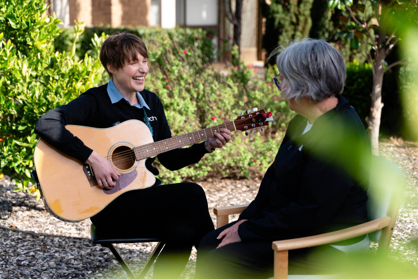 Resident enjoying guitar lessons led by ECH employee in Music Therapy Class