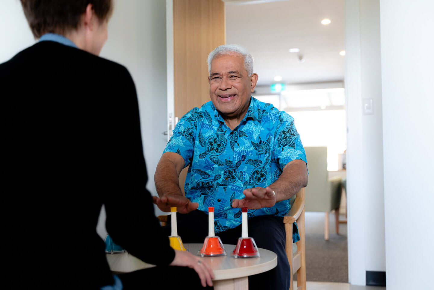 ECH resident playing music in Music Therapy class with ECH employee